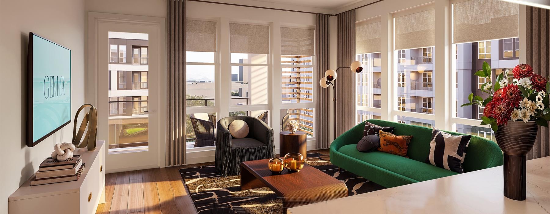 Open space living area with natural lighting and a green couch